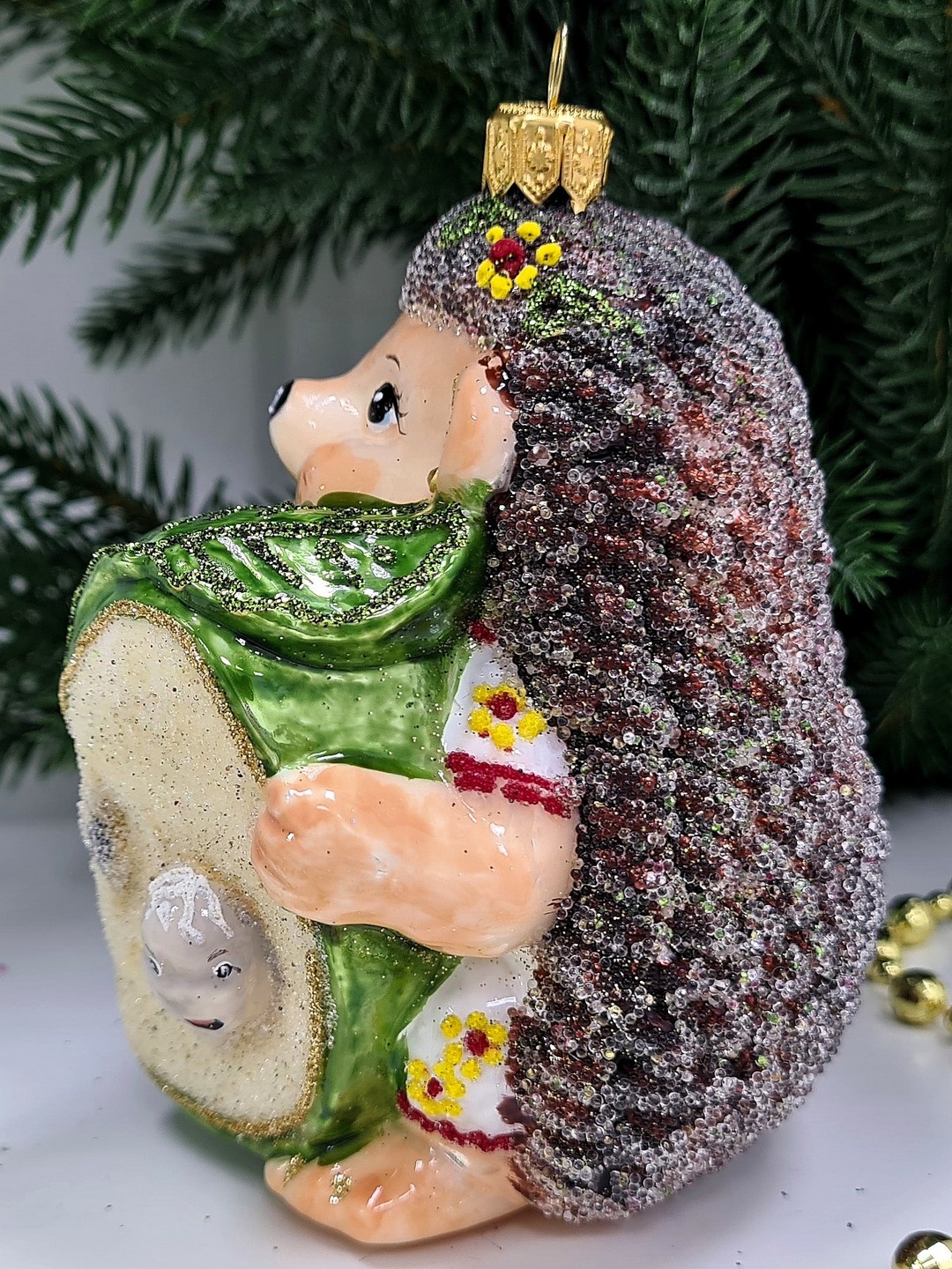 фото Стеклянная елочная игрушка Ежик с яблоком девочка